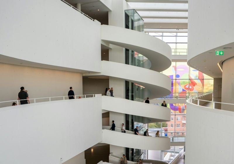 Spiralling white ramps inside a bright modern atrium