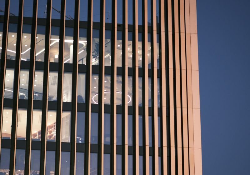 Residential building facade with warm interior light at dusk